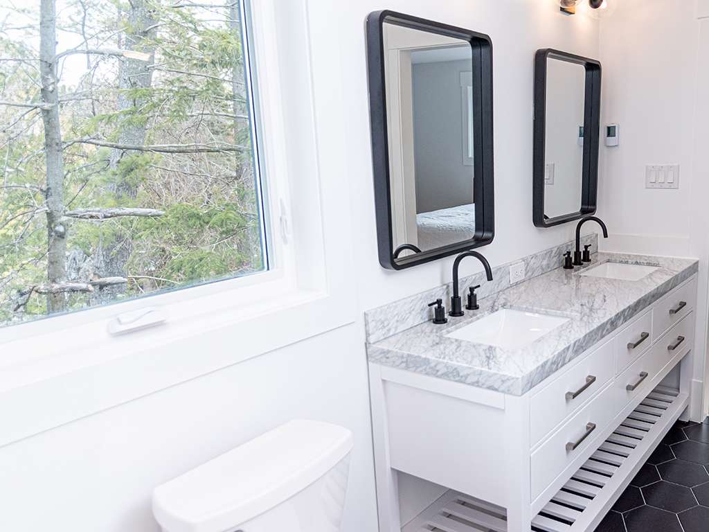 Bathroom renovation with forest views in a Wasaga Beach custom home by Revel Homes