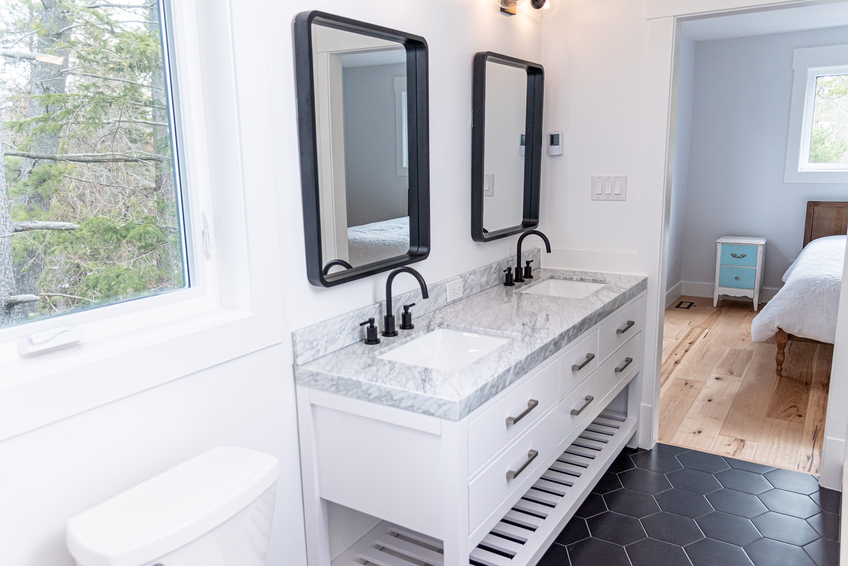 Luxury ensuite with marble double vanity and freestanding tub filler in a custom home by Revel Homes, serving the Blue Mountains