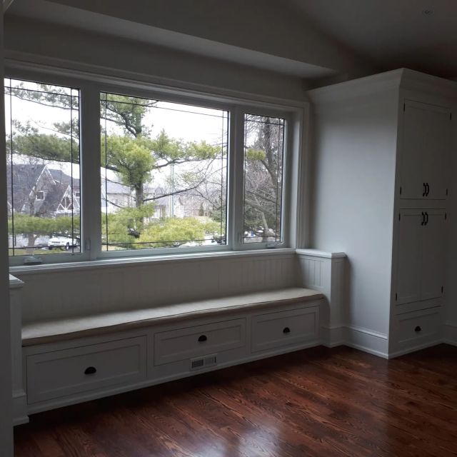 Custom window bench and built-in cabinetry crafted by Revel Homes