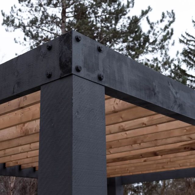 Black timber pergola joinery detail on a rural custom build by Revel Homes