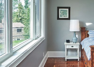 Bedroom renovation with hardwood floors by Revel Homes