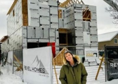 Custom home framing stage with Revel Homes site sign